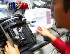 Vacuum repair technician servicing internal components on a workbench in Columbia, SC