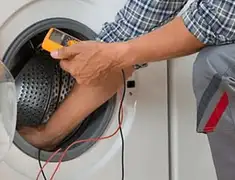 Washing machine repair technician testing a front-load washer with diagnostic tools in Columbia, SC